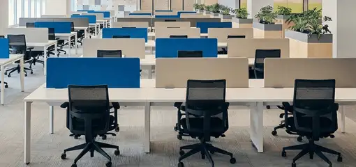Modern open-plan office space featuring clean workstations, ergonomic chairs, and sanitized carpets provided by professional office cleaning services in Scottsdale, AZ.